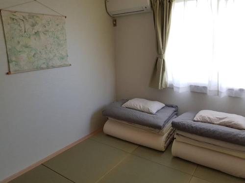 Postel nebo postele na pokoji v ubytování Sen Guesthouse