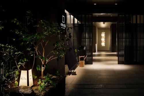 a hallway of a building with a plant at Hotel Resol Kyoto Shijo Muromachi in Kyoto