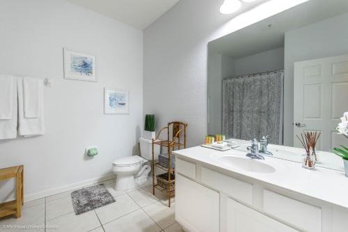 a white bathroom with a sink and a toilet at Orlando Escape in Orlando