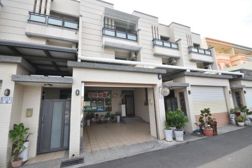 a large white building with a store in it at 世外桃園民宿 in Taitung City