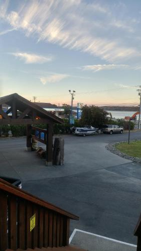 a parking lot with a gas station with cars parked at Big Rock Motel in Campbell River