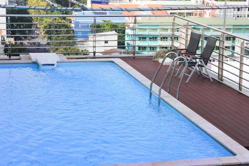 a swimming pool on the roof of a building at New Pacific Hotel in Ho Chi Minh City