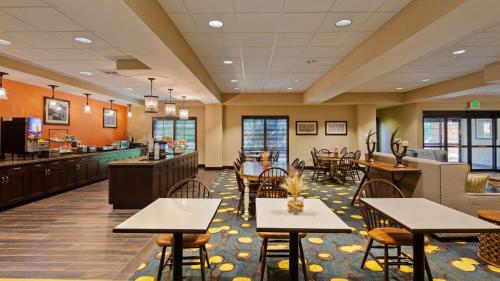 un ristorante con tavoli e sedie e un bar di Best Western Plus Dayton a Dayton