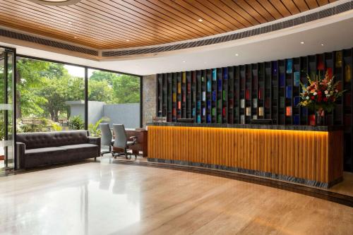 a lobby with a large wall of wine bottles at Ramada Encore Jalandhar in Jalandhar