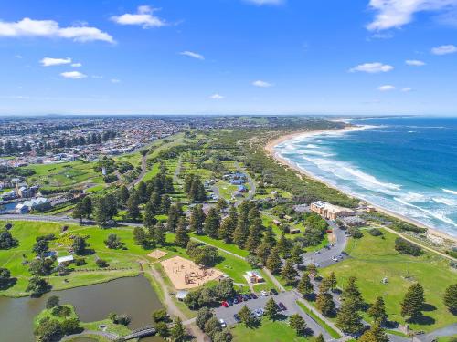 an aerial view of the beach and the ocean at Surfside Holiday Park Warrnambool in Warrnambool