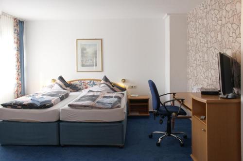 מיטה או מיטות בחדר ב-Hotel Haarener Hof
