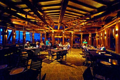 a restaurant with people sitting at tables in a building at Coconuts Beach Club Resort and Spa in Fausaga