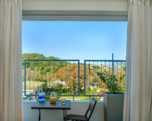 a room with a table and a window with a view at Royal St. Andrews Hotel, Spa and Conference Centre in Port Alfred