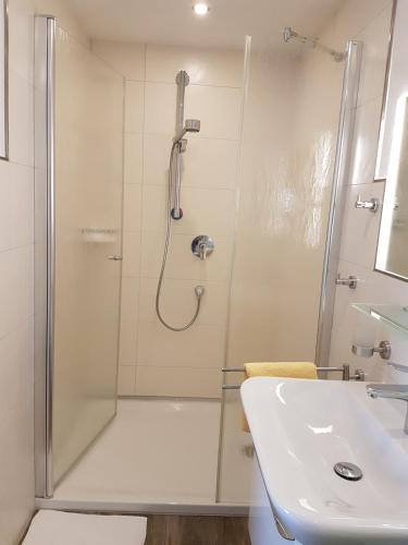 a bathroom with a shower and a sink at Hotel Garni Fuhrhop in Bad Karlshafen
