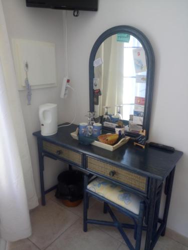 a bathroom vanity with a mirror and a sink at Les Mouettes in La Cotinière