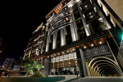 a large building with lights on it at night at KUN Hotel in Taichung