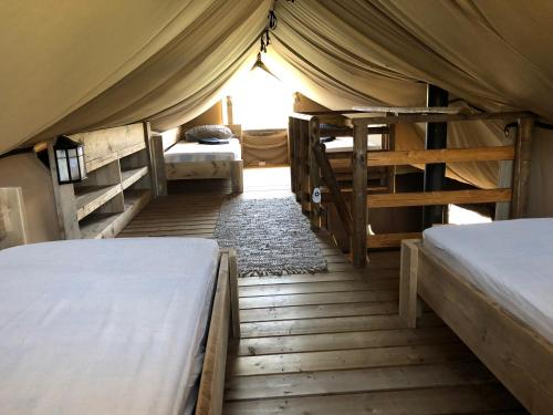 a bedroom with two beds in a tent at Cortijo Dos Santos in Valle de Abdalagís