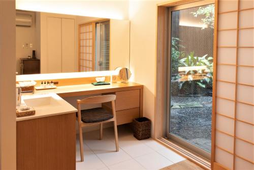 a bathroom with a sink and a mirror at Auberge AZABU in Kyoto