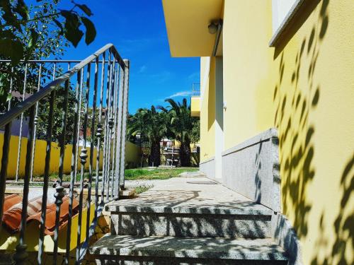 a stairway leading up to a yellow building at B&B 500 Miglia  in Tempio Pausania