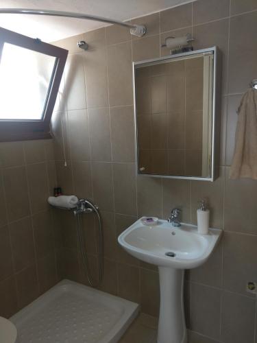 a bathroom with a sink and a mirror at Prokymaia Apartment 2 in Áyios Andónios