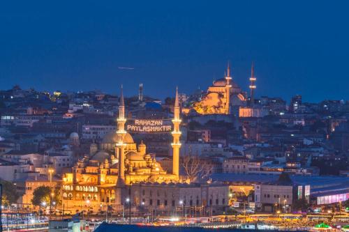 a view of a city at night with mosques at Galatower Hotel in Istanbul