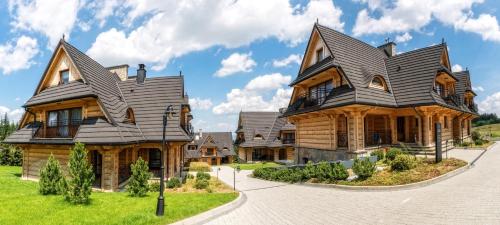 a large wooden house with a gambrel roof at Rezydencja NOVA na Gubałówce in Zakopane