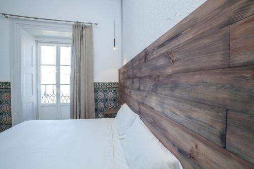 Postel nebo postele na pokoji v ubytování Apartahotel Siglo XIX