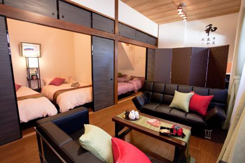 a living room with a couch and a bedroom at Nagomi House in Tokyo