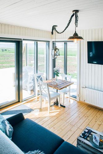 a living room with a couch and a table at Akurgerði Guesthouse 6 - Country Life Style in Ölfus