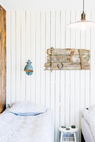 a bedroom with a bed and a wooden sign on the wall at Akurgerði Guesthouse 6 - Country Life Style in Ölfus