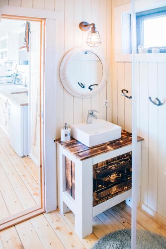 a bathroom with a white sink and a mirror at Akurgerði Guesthouse 6 - Country Life Style in Ölfus