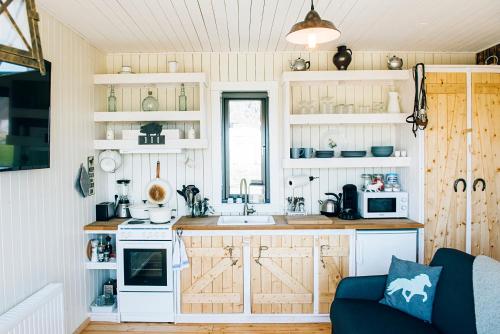 a kitchen with white cabinets and a counter top at Akurgerði Guesthouse 6 - Country Life Style in Ölfus