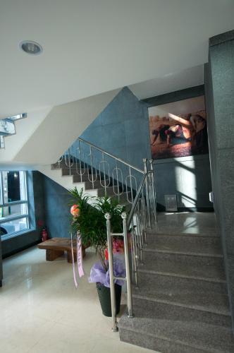 a staircase in a building with a potted plant at Residence Mumum Hotel in Busan