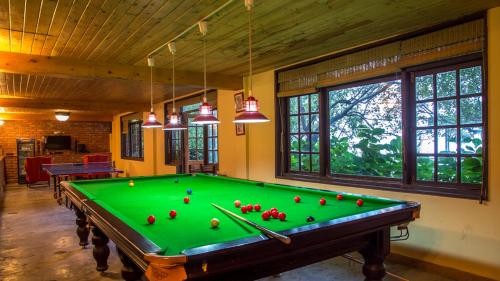 a room with a pool table with balls on it at Mahasu House in Shimla