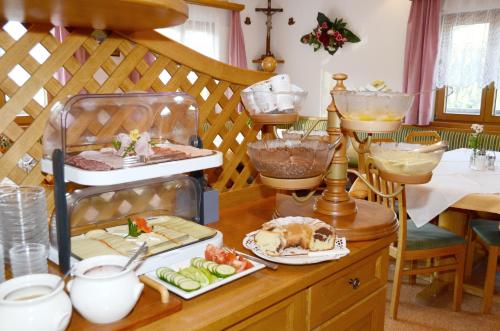 a kitchen with a table with food on it at Ferienhof Wölflbauer in Saalbach Hinterglemm