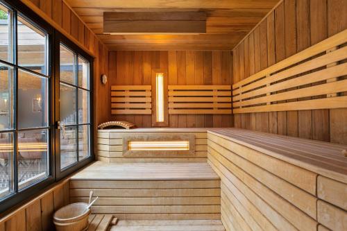 an empty sauna with wooden walls and windows at Puur B&B in Antwerp