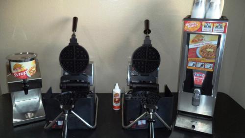 a ticket machine and a drink dispenser on a counter at Days Inn by Wyndham Maumee/Toledo in Maumee