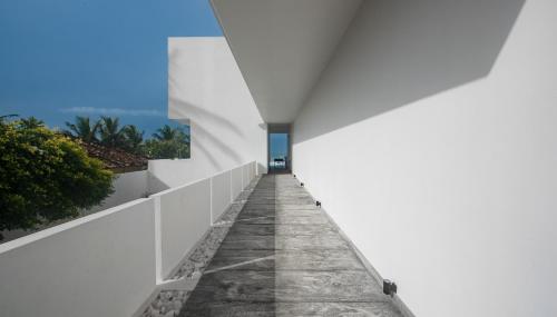 a view of the hallway of a white building with the horizon at Sielen Diva in Unawatuna