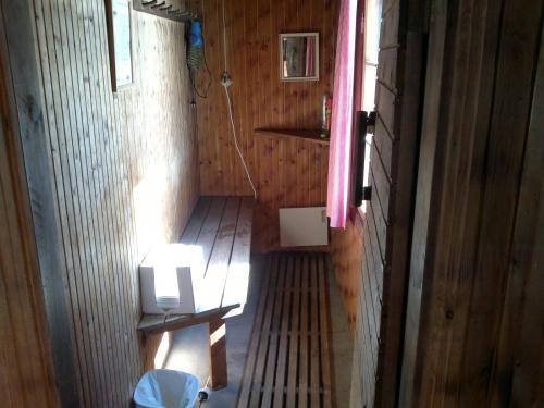 an inside view of a wooden room with a toilet at Hotel Stallbacken Nagu in Nauvo