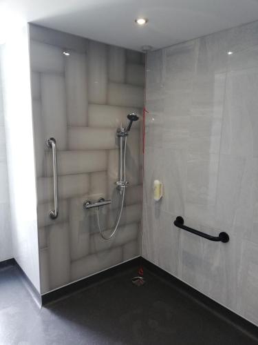 a shower stall in a bathroom with a shower at The Old Borough Hotel - Wetherspoon in Swords