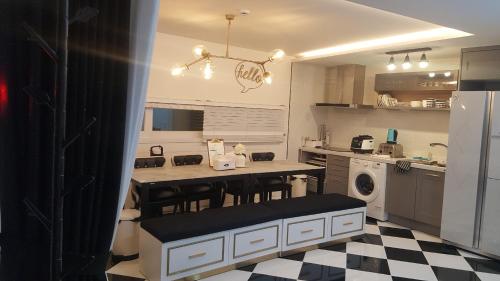 a kitchen with a black and white checkered floor at HANI Haus in Jeju