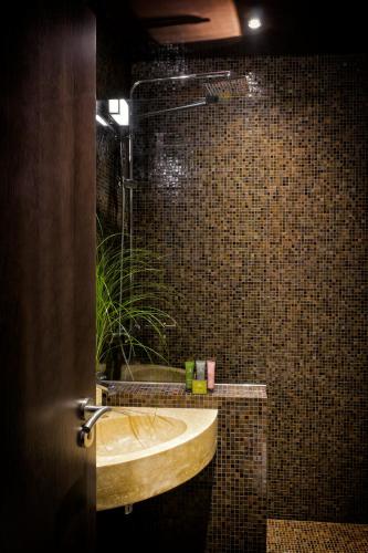a bathroom with a sink and a glass shower at B Montmartre in Paris