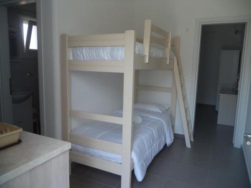 a couple of bunk beds in a room at Taxiarchis Studios in Áyios Yeóryios
