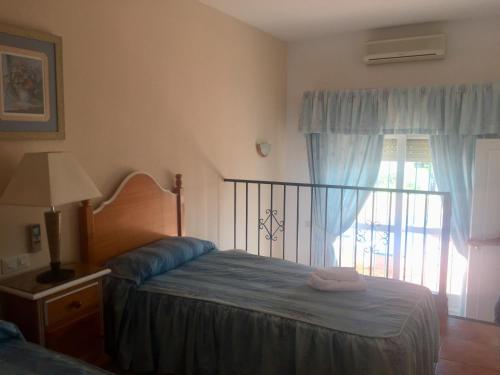 a bedroom with a bed and a window at Marbesa Villas with Jacuzzi in Marbella