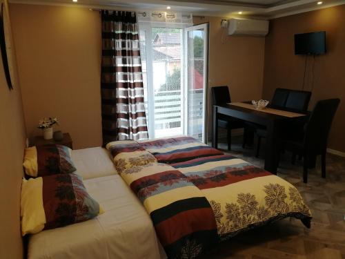 Postel nebo postele na pokoji v ubytování Apartman Bogić