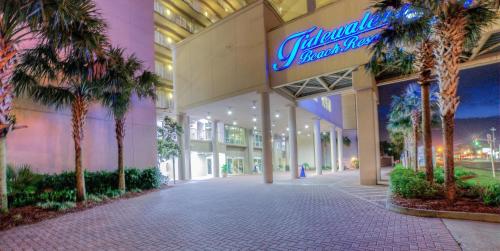 a mall with palm trees in front of a building at Tidewater Beach Resort 1818 By Aneliya in Panama City Beach