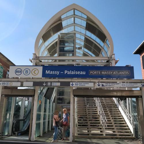 people standing in front of a glass building at Les Clés du Bonheur by Beds4Wanderlust, 47m2 avec Terrasse privative & Parking-RER B TGV 10min-Orly 20min in Massy