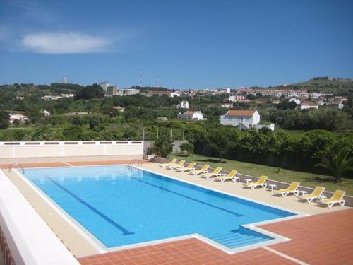 a large swimming pool with lounge chairs at Quinta de Malmedra in Santiago do Cacém