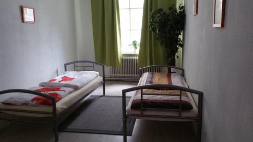 a room with two beds and a window at Casa Mario in Bremen