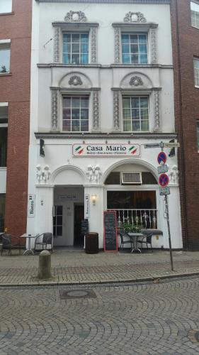 a white building with a sign in front of it at Casa Mario in Bremen