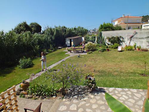 a little girl is standing in a garden at Casa da Lis in Salir de Porto