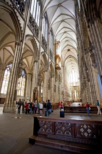 a large cathedral with people walking around in it at Ibis budget Koeln Messe in Cologne