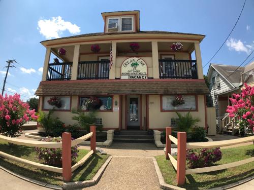 a building with a balcony on top of it at Ocean Cove Motel in Virginia Beach