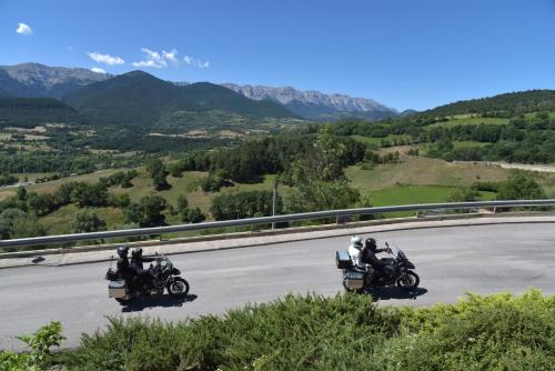 a group of three motorcycles driving down a road at Cerdanya Viva Ecoestades in Prullans