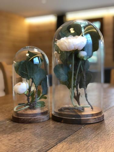 a glass dome with a flower in it on a table at Chalet de charme, le "Caribou Lodge", Eifel belge in Bullange